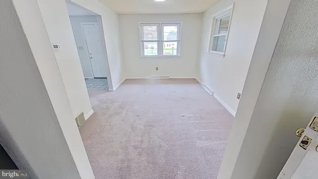 a view of room with window and hardwood floor