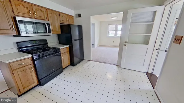 a kitchen with a refrigerator stove and cabinets
