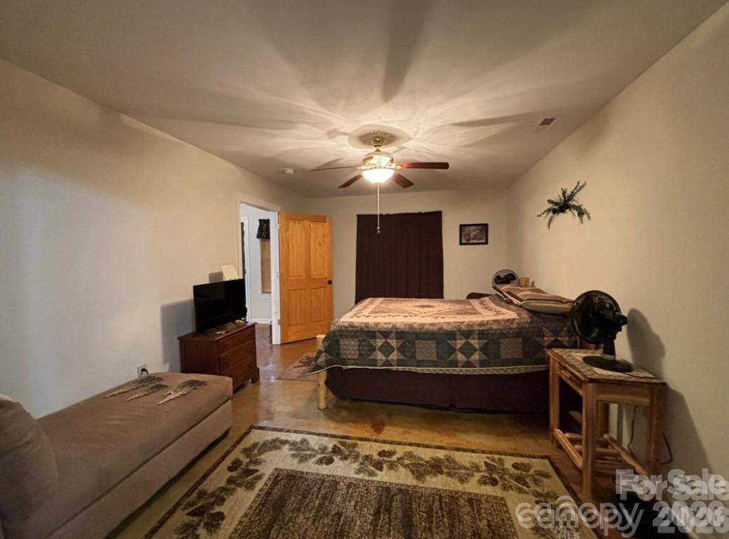 369 Pinecrest Circle Troy, NC 27371 - Photo 11 of 19 a bedroom with a bed and a chandelier
