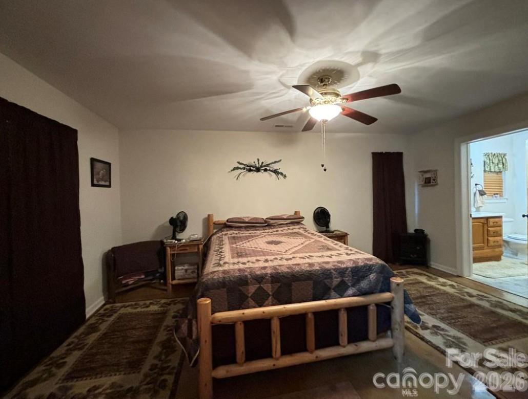 369 Pinecrest Circle Troy, NC 27371 - Photo 12 of 19 a bedroom with bed and a chandelier