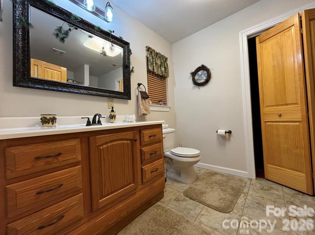 369 Pinecrest Circle Troy, NC 27371 - Photo 14 of 19 a bathroom with a toilet sink and mirror