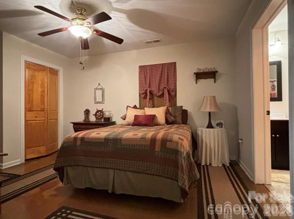369 Pinecrest Circle Troy, NC 27371 - Photo 15 of 19 a bedroom with a bed and wooden floor