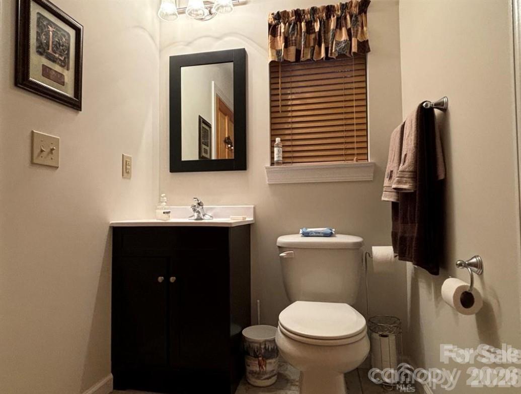 369 Pinecrest Circle Troy, NC 27371 - Photo 16 of 19 a bathroom with a toilet sink and mirror