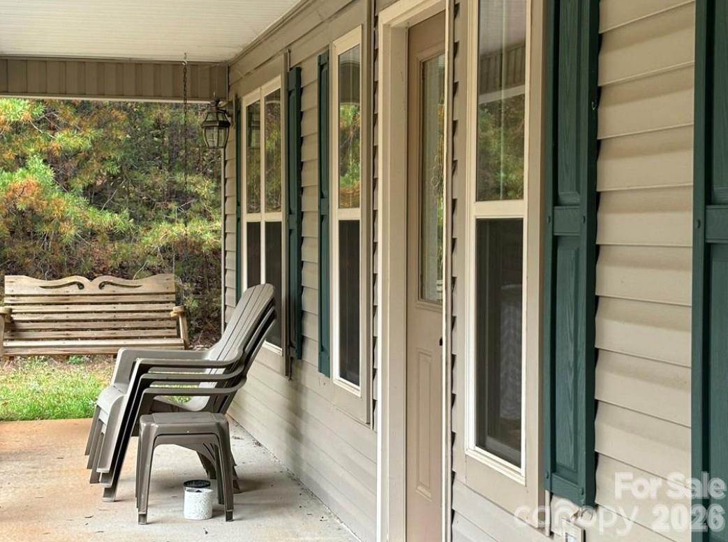 369 Pinecrest Circle Troy, NC 27371 - Photo 3 of 19 a view of a balcony with chair and front door