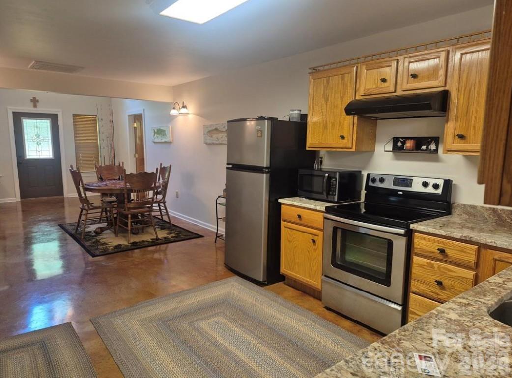 369 Pinecrest Circle Troy, NC 27371 - Photo 8 of 19 a kitchen with stainless steel appliances granite countertop a stove a refrigerator and a microwave