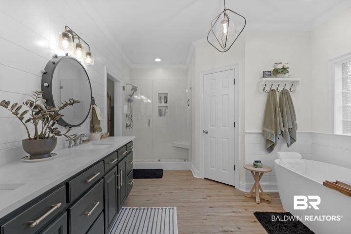 24541 Baldwin Beach Expressway Robertsdale, AL 36567 - Photo 18 of 51 Full bath featuring crown molding, a sink, a stall shower, double vanity, and wood finished floors