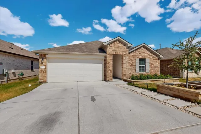 a view of a house with a yard and garage