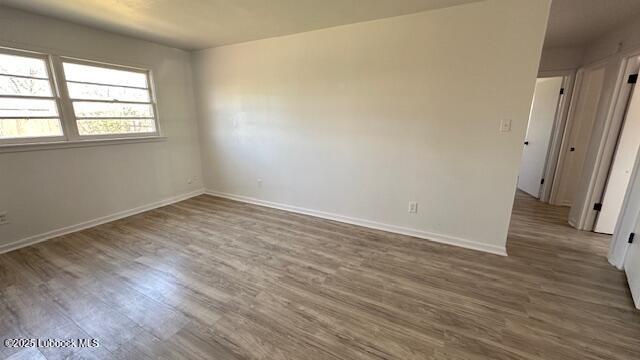 5110 46th Street Lubbock, TX 79414 - Photo 15 of 17 an empty room with wooden floor and a window
