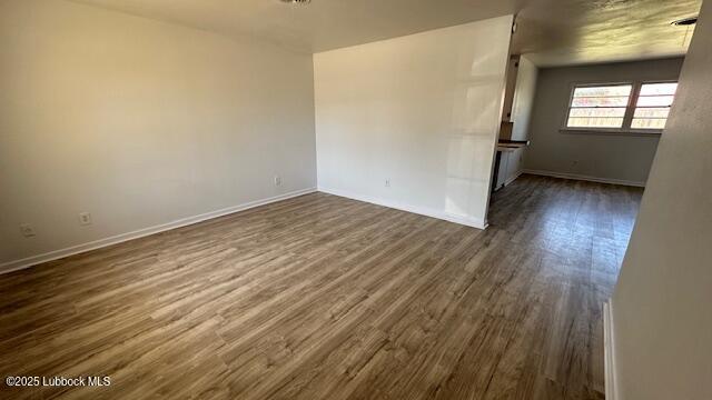 5110 46th Street Lubbock, TX 79414 - Photo 2 of 17 an empty room with wooden floor and windows