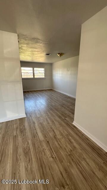 5110 46th Street Lubbock, TX 79414 - Photo 3 of 17 a view of empty room with wooden floor