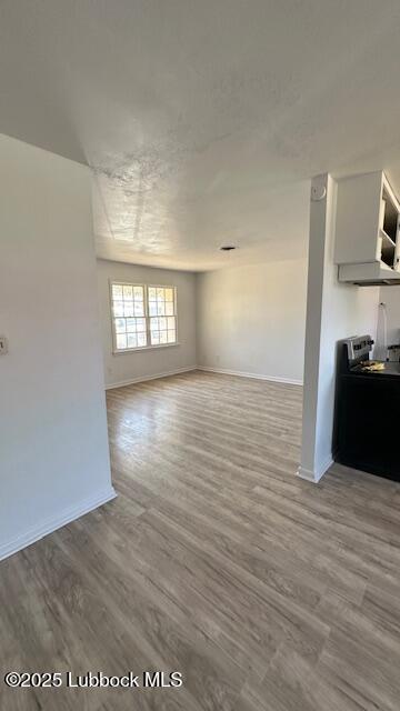 5110 46th Street Lubbock, TX 79414 - Photo 4 of 17 a view of wooden floor and windows in a room