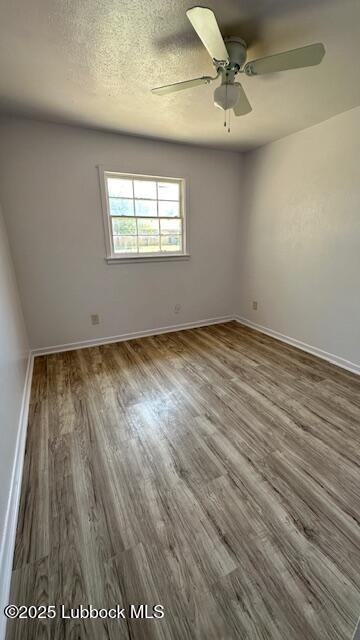 5110 46th Street Lubbock, TX 79414 - Photo 8 of 17 an empty room with wooden floor fan and windows
