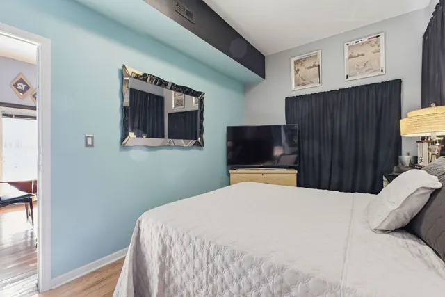 a living room with lots of furniture and painting on the wall