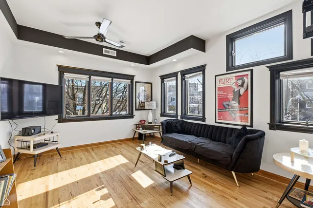 a view of a livingroom with wooden floor and a window