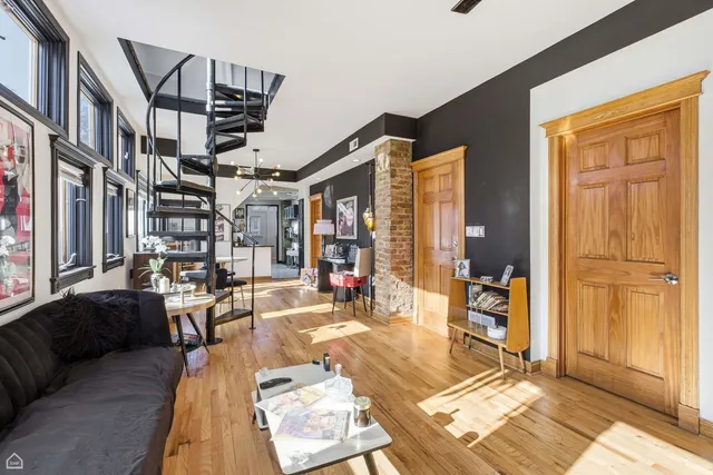 a bedroom with a bed couch and a large window