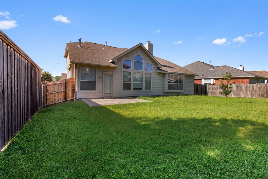 2700 Hereford Road Denton, TX 76210 - Photo 31 of 36 Expansive backyard featuring a large grass area, wood privacy fencing, and a concrete patio