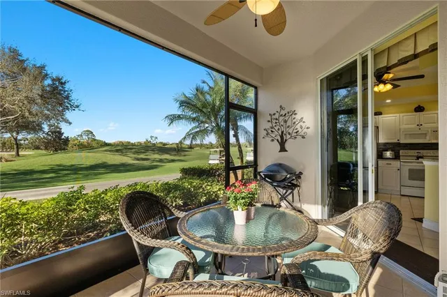 a dining room with furniture and a floor to ceiling window
