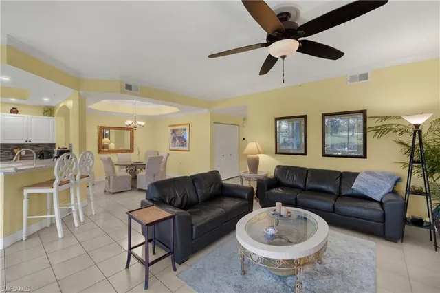 a living room with furniture a ceiling fan and a rug
