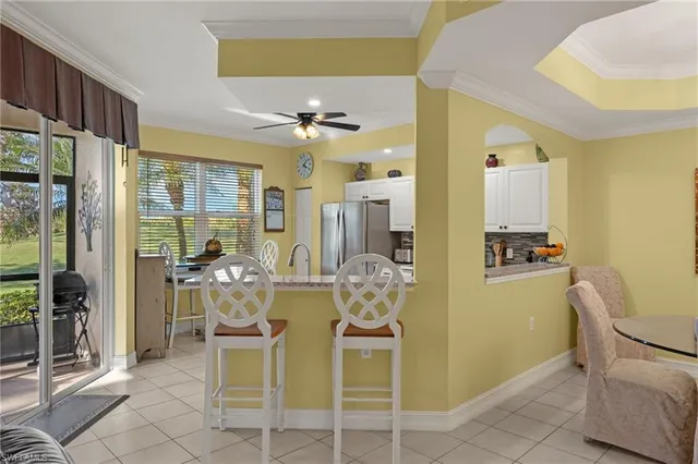 a view of a dining room with furniture and a chandelier