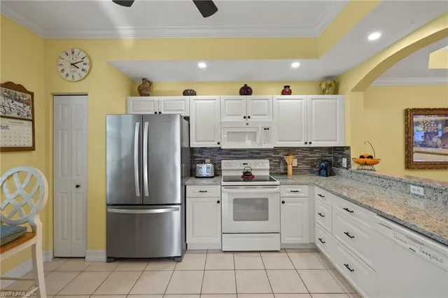 a kitchen with a refrigerator sink and cabinets