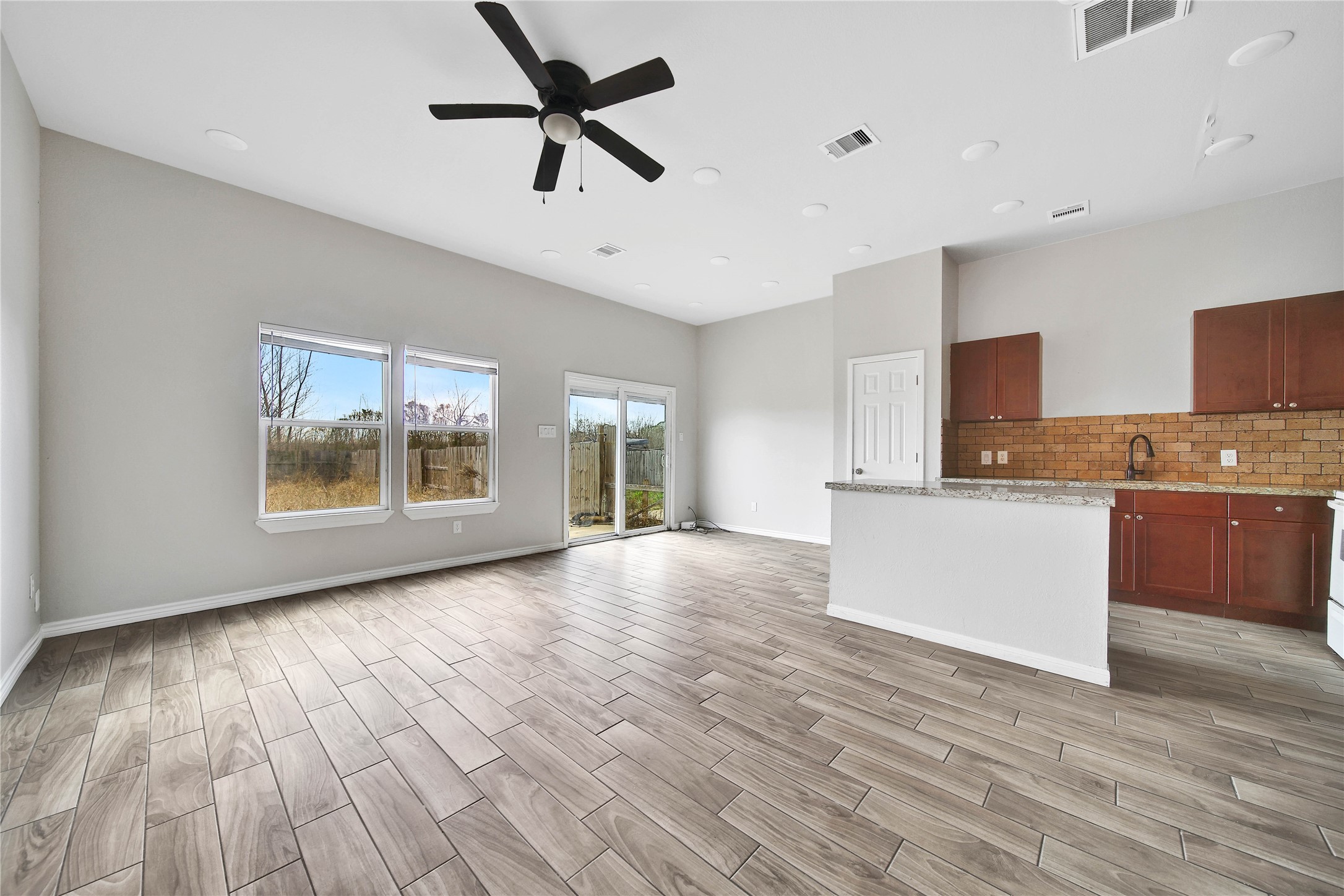 8034 Crestview Drive Houston, TX 77028 - Photo 2 of 15 a view of an empty room with a window and wooden floor
