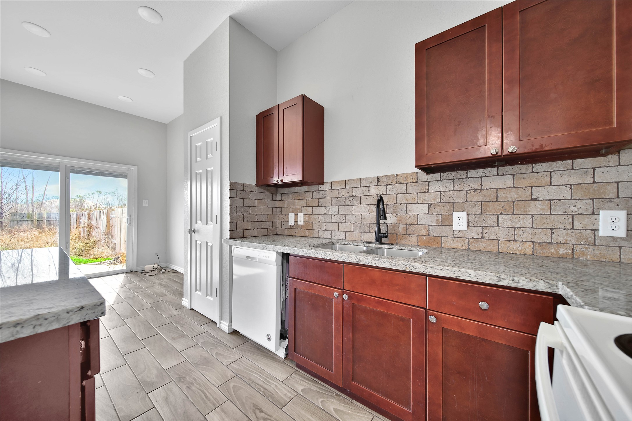 8034 Crestview Drive Houston, TX 77028 - Photo 5 of 15 a kitchen with stainless steel appliances granite countertop a sink stove and cabinets