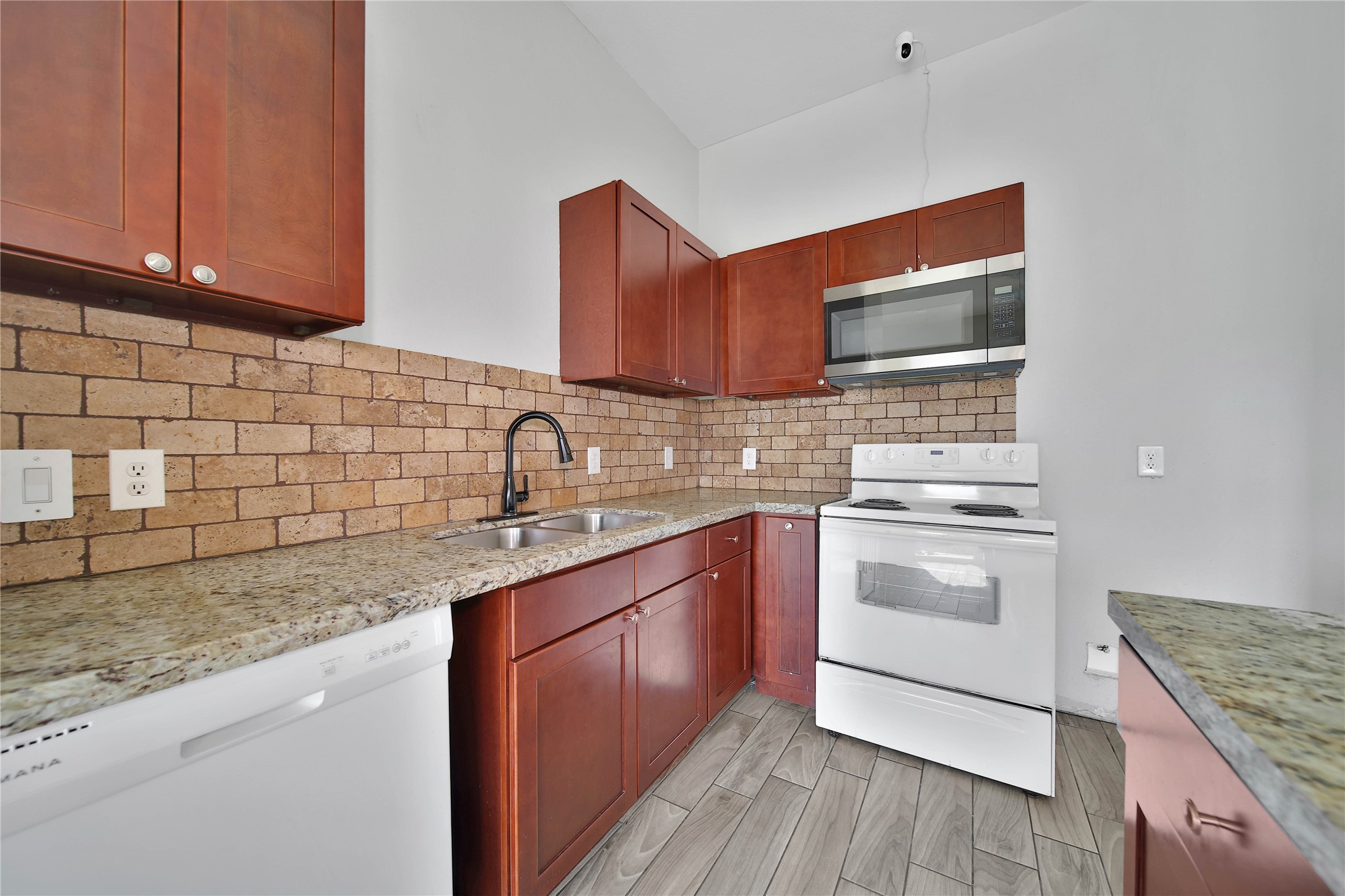 8034 Crestview Drive Houston, TX 77028 - Photo 6 of 15 a kitchen with stainless steel appliances granite countertop a sink stove and cabinets