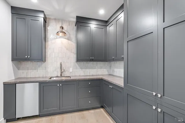 a kitchen with a sink and cabinets