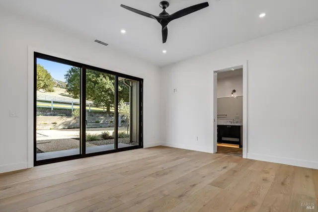 a view of a livingroom with a ceiling fan and window