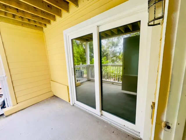 a view of a glass door with wooden floor