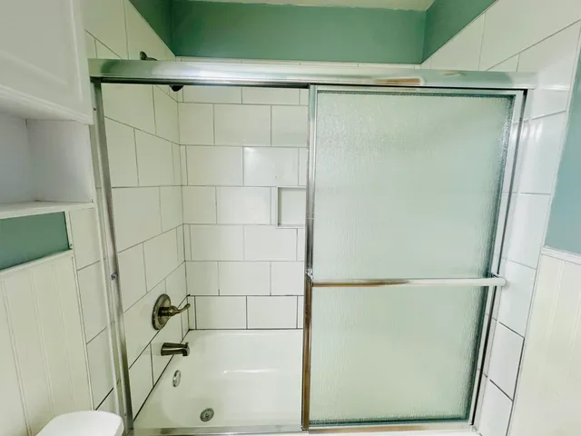 a bathroom with a shower and a toilet