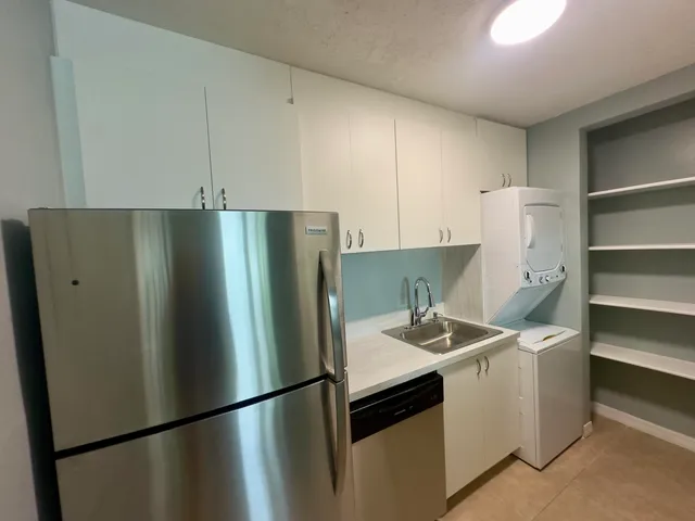 a kitchen with a refrigerator and a sink