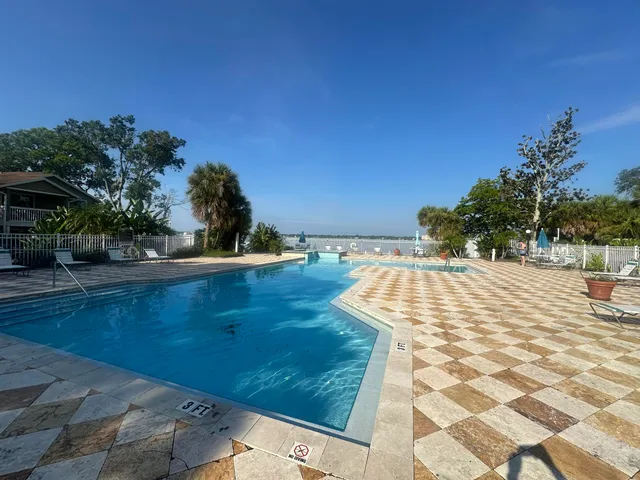 a view of a swimming pool with an outdoor space and seating area
