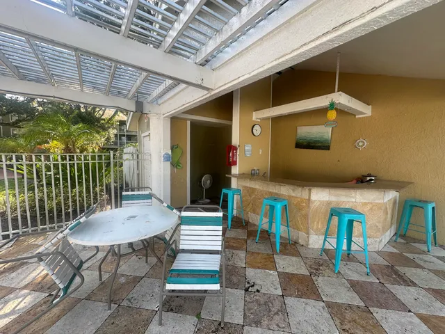 a view of a chairs and table in patio