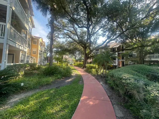 a view of a brick house with a yard