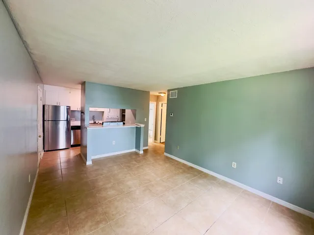a view of kitchen and refrigerator
