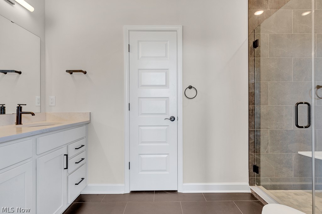 3601 Bailey Avenue Cleveland, OH 44113 - Photo 15 of 22 Bathroom with tile floors, oversized vanity, and a shower with door