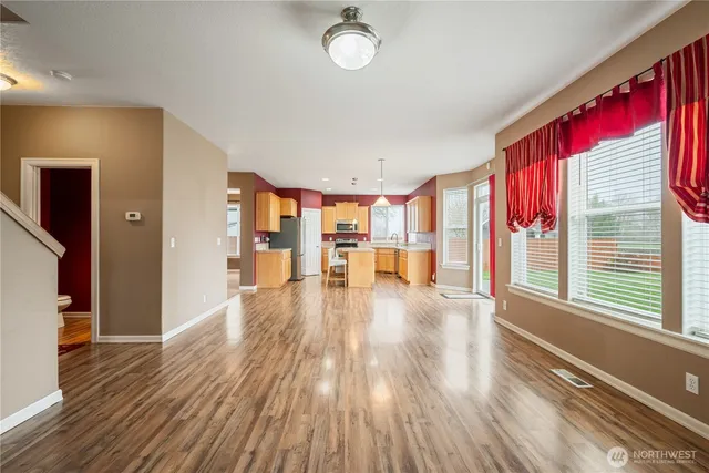 a view of a living room with furniture and wooden floor
