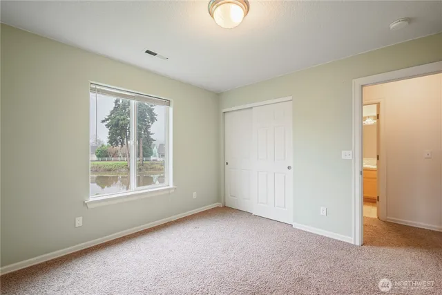 an empty room with windows and closet