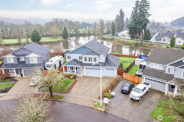 an aerial view of a house with garden space and street view