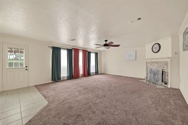 a view of a livingroom with a fireplace and window