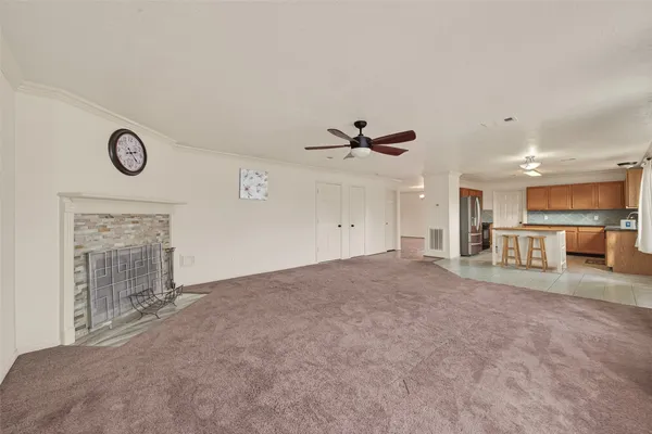 a kitchen with granite countertop a stove a sink and a refrigerator