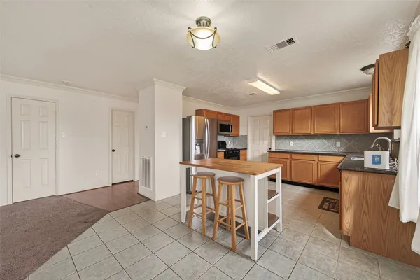 a kitchen with granite countertop stainless steel appliances and cabinets