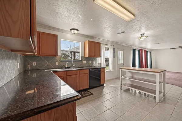 a kitchen with stainless steel appliances granite countertop a stove and a microwave