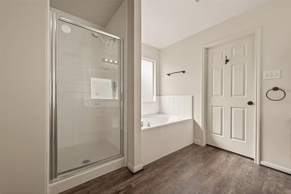 a spacious bathroom with a double vanity sink a mirror and bathtub