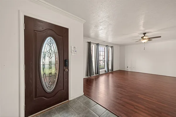 a view of a livingroom with wooden floor and a large window