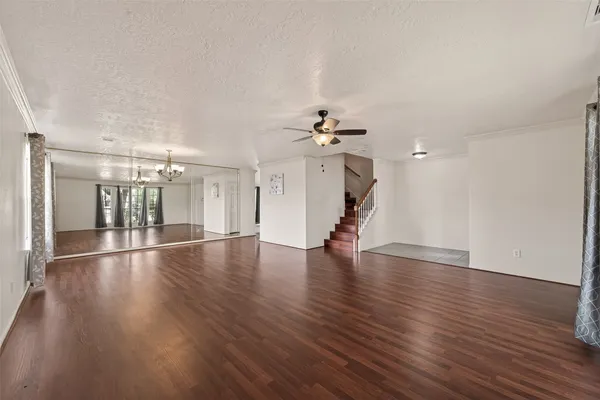 a view of a room with wooden floor