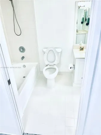 a bathroom with a granite countertop sink a toilet and bathtub