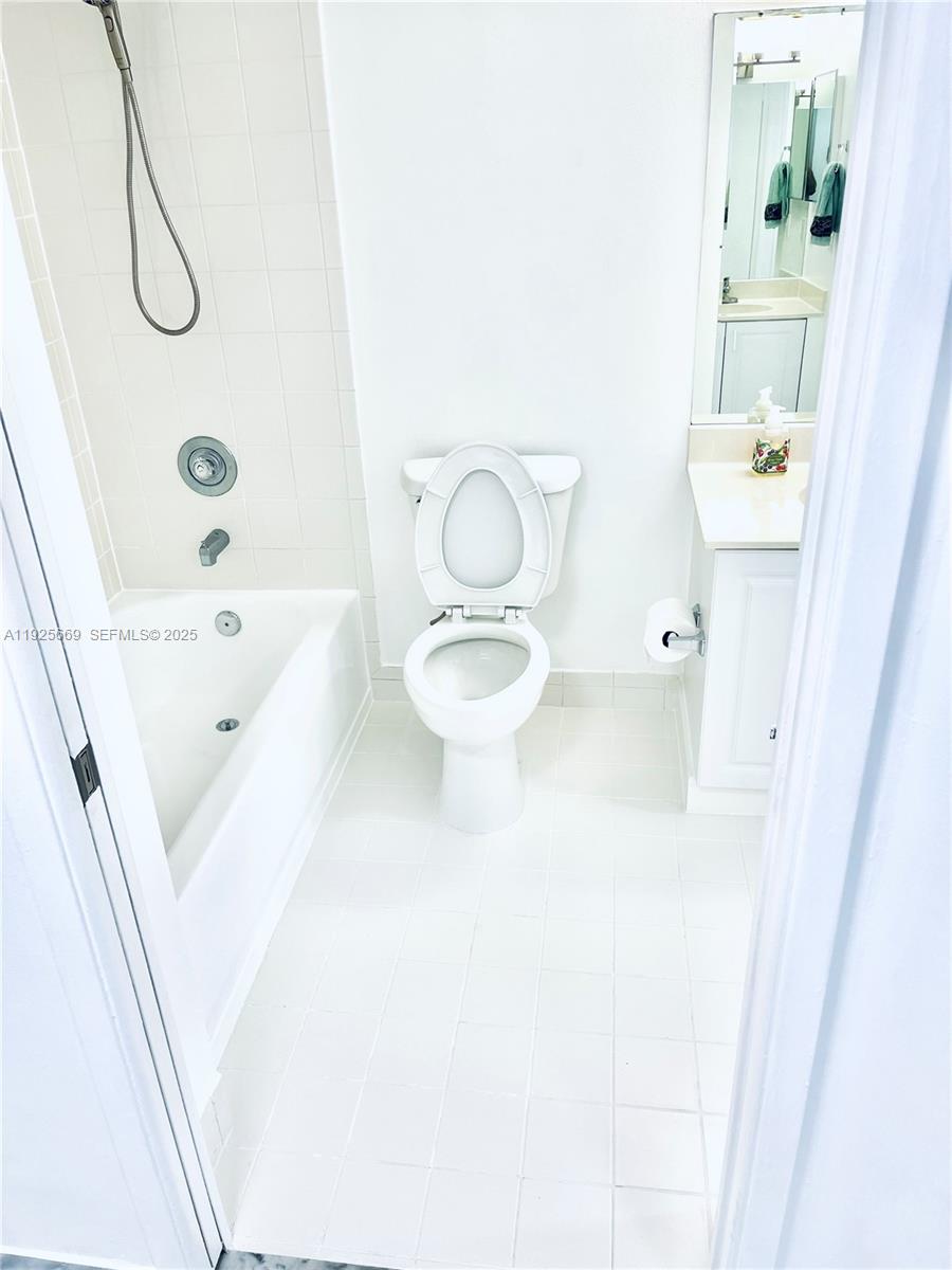 6801 Harding Avenue, Unit 306 Miami Beach, FL 33141 - Photo 11 of 30 a bathroom with a toilet sink and shower