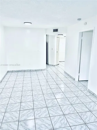 a view of a livingroom with an empty space and window